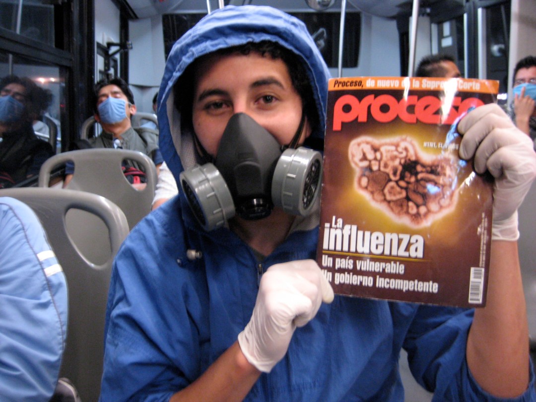 THE RIGHT GEAR: Mexico City  bus rider holds up the latest issue of the Mexican news magazine Proceso, featuring a story on swine influenza.