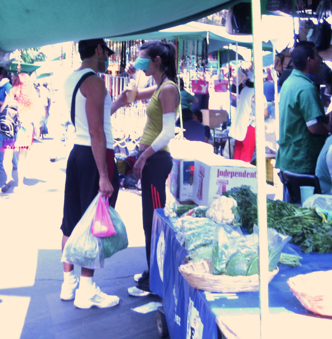 THIRSTY?: A couple shares a fruit juice at the Sunday market in Colonia Del Valle in Mexico City. The Mexican government ordered bars and clubs closed for the next 10 days. 
